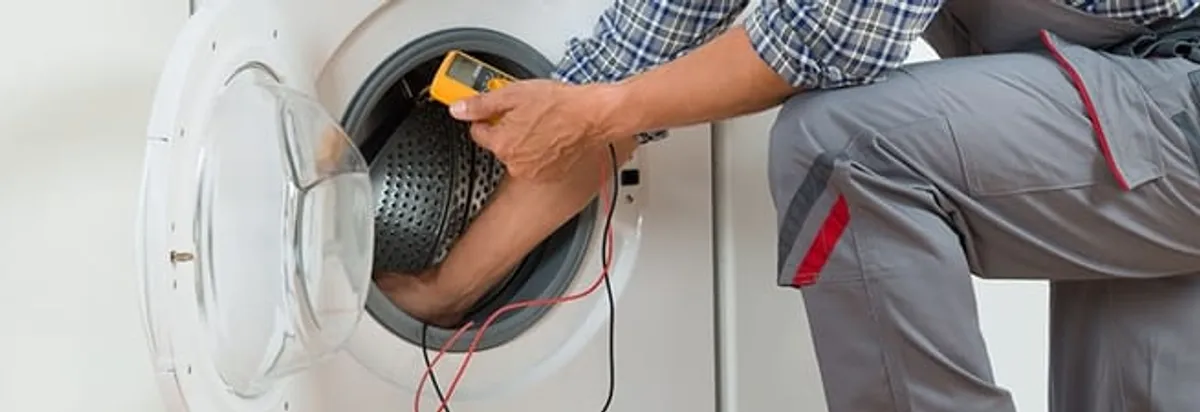 Dryer repair technician inspecting and repairing a clothes dryer in Albany, NY